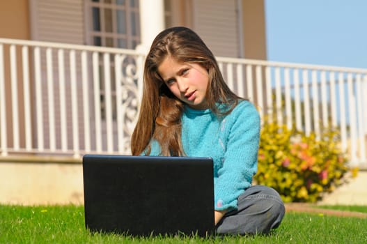 Girl on the grass with laptop