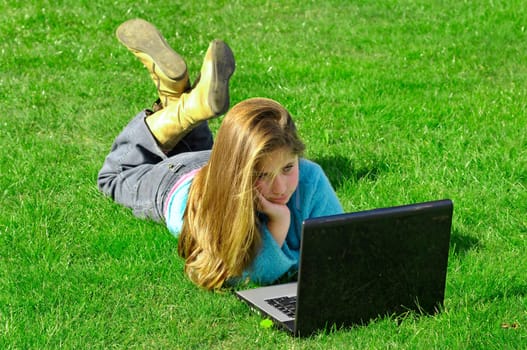 Girl on the grass with laptop