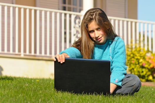 Girl on the grass with laptop