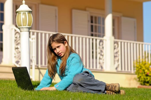 Girl on the grass with laptop