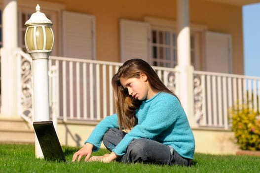 Girl on the grass with laptop