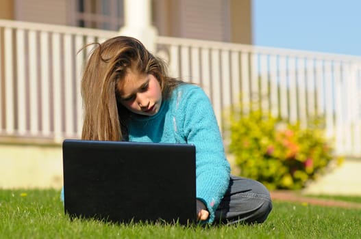 Girl on the grass with laptop