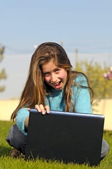 Girl on the grass with laptop