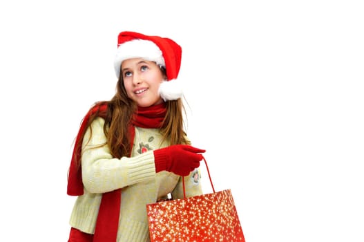 Beautiful young girl with santas hat and shopping bags isolated in white
