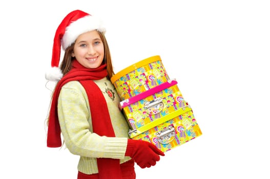 Beautiful young girl with santas hat and gif boxes isolated in white
