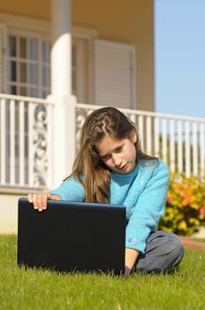 Girl on the grass with laptop