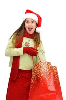 Beautiful young girl with santas hat and shopping bags isolated in white
