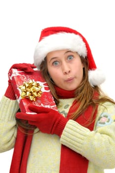 Beautiful young girl with santas hat and shopping bags isolated in white