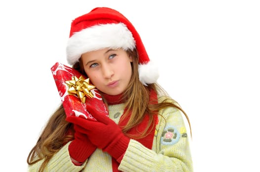Beautiful young girl with santas hat and shopping bags isolated in white