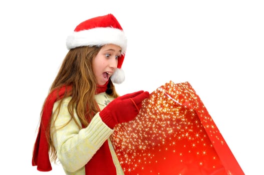 Beautiful young girl with santas hat and shopping bags isolated in white