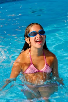 Young girl jumping on a pool