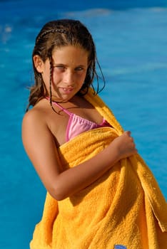 Beautiful young girl posing in a pool