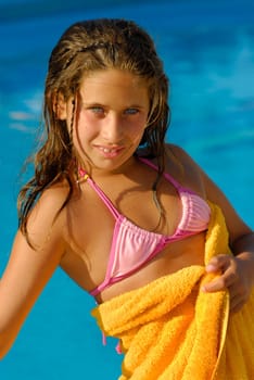 Beautiful girl posing in a swimming pool