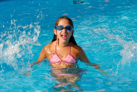 Young girl playing on the pool