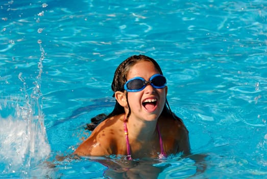Yong girl playing on the pool