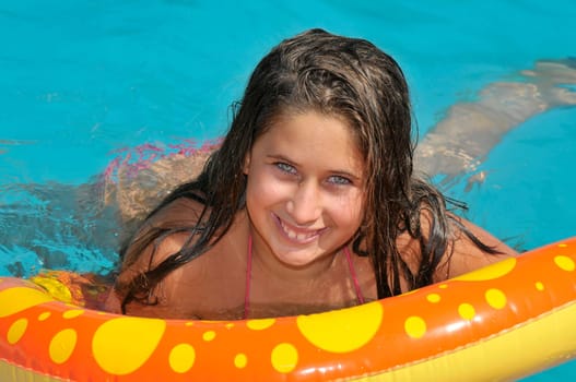 Beautiful girl posing in a swimming pool