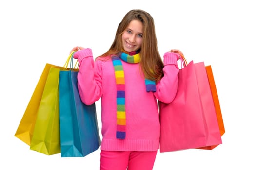 Beautiful young girl with colorful bags isolated in white