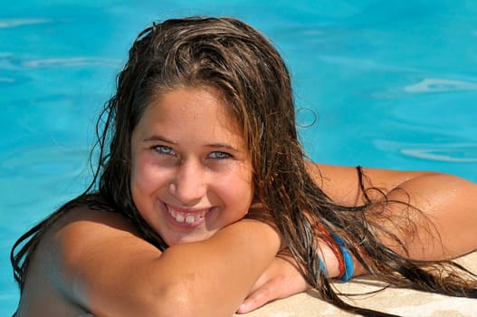 Beautiful girl posing in a swimming pool