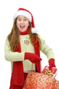 Beautiful young girl with santas hat and shopping bags isolated in white