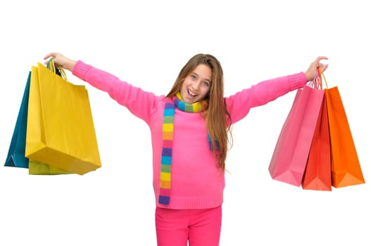 Beautiful young girl with colorful bags isolated in white