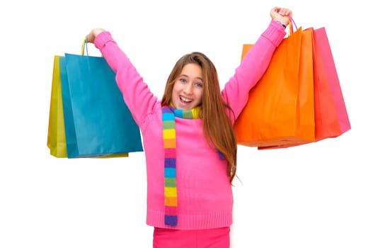 Beautiful young girl with colorful bags isolated in white