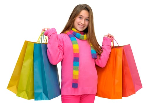 Beautiful young girl with colorful bags isolated in white