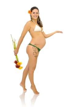 Pregnant woman with tattoo in bikini holding a bunch of flowers isolated in white