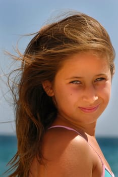 Beautiful young girl posing in the beach