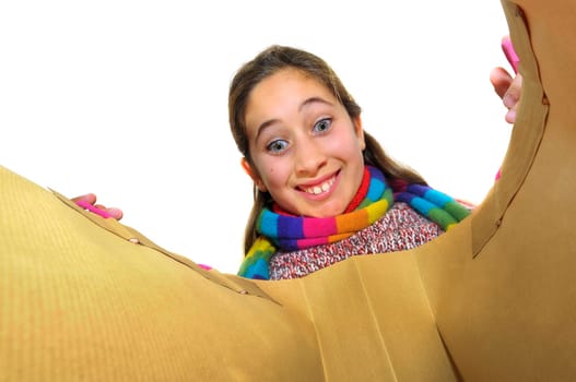 Beautiful young girl looking inside colorful bag isolated in white