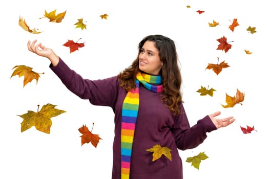 Beautiful teen with leaves falling all around isolated in white
