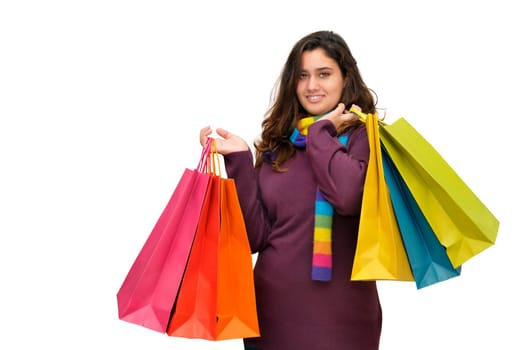 Beautiful teen with colorful bags isolated in white