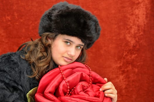 Beautiful girl with roses isolated in a red background