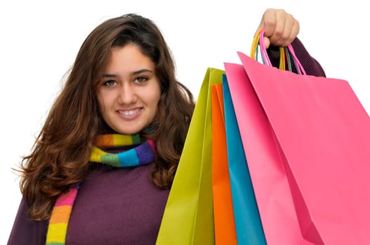 Beautiful teen with colorful bags isolated in white