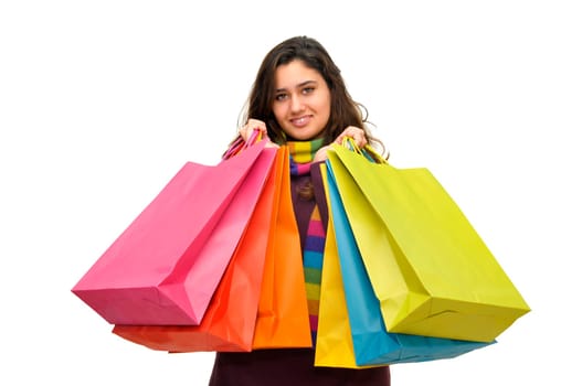 Beautiful teen with colorful bags isolated in white