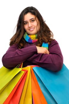 Beautiful teen with colorful bags isolated in white