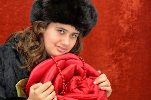 Beautiful girl with roses isolated in a red background