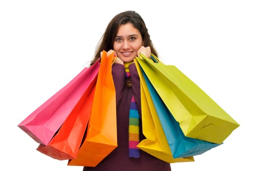 Beautiful teen with colorful bags isolated in white