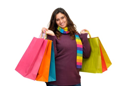 Beautiful teen with colorful bags isolated in white