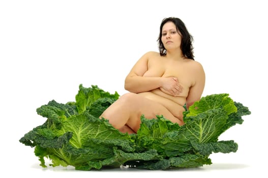 Beautiful large girl with vegetables isolated in white