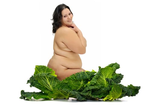 Beautiful large girl with vegetables isolated in white