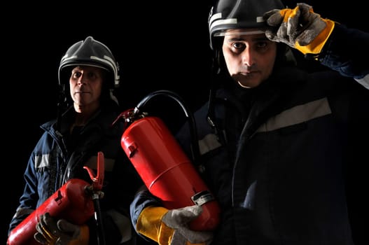 Dramatic image of firemen team in uniform