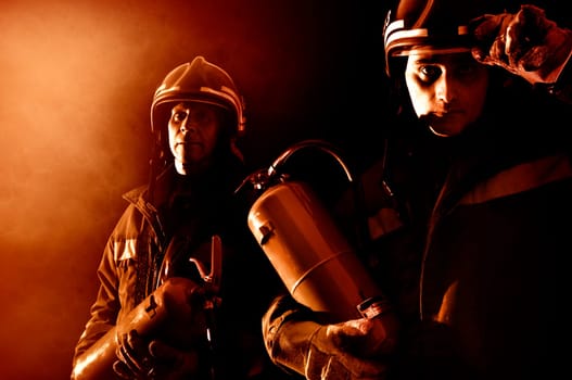 Dramatic image of firemen team in uniform