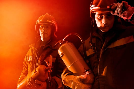 Dramatic image of firemen team in uniform