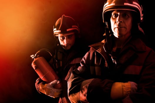Dramatic image of firemen team in uniform