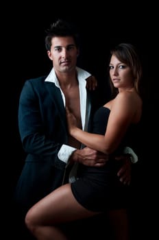 Sexy young couple isolated in black