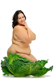 Beautiful large girl with vegetables isolated in white