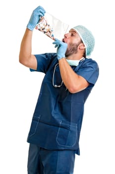 Doctor with pills against a white background