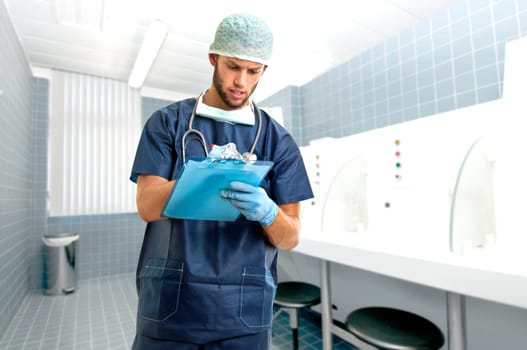 Young doctor in uniform writing in a pad