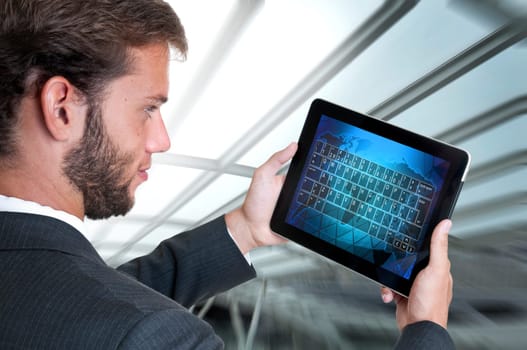 Young businessman with tablet isolated in white