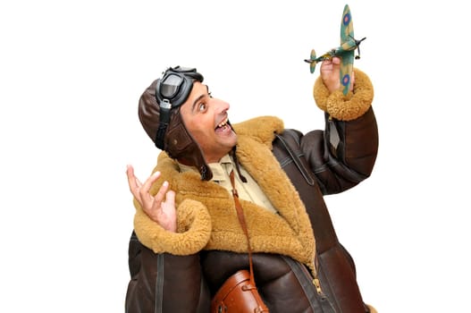 Fighter pilot with model plane isolated in white